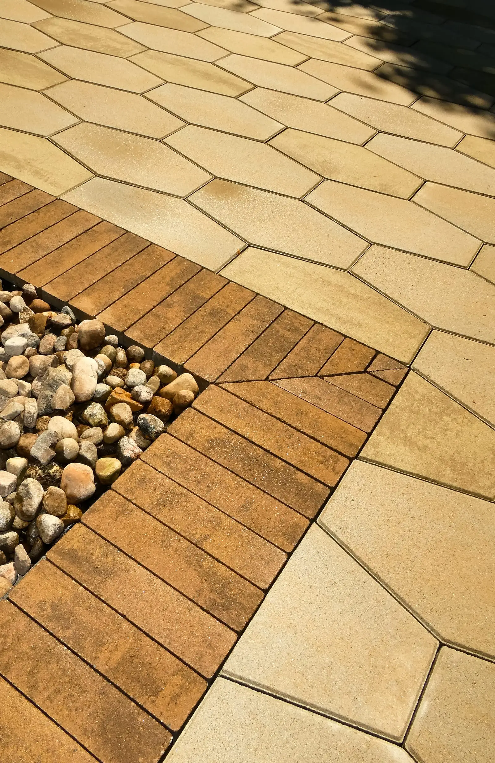 The clay-brick banding seen closer, each course cut to meet the hexagonal field cleanly along its full length